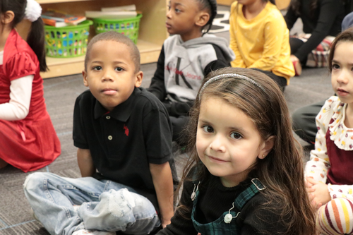 Students sit on the floor in class